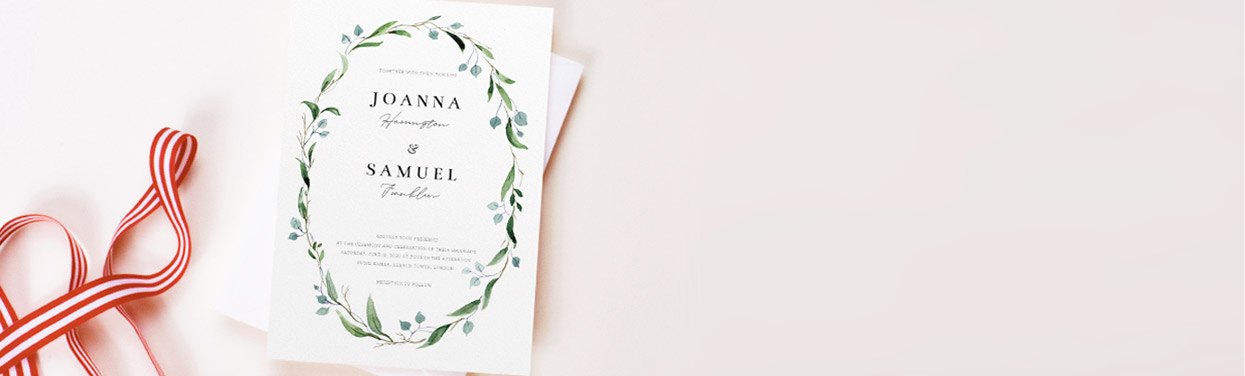 A personalised and printed wedding invitation cards. The card is a green floral wedding invitation with a cursive script.